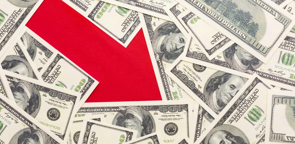 top-view-arrow-showing-decrease-with-banknotes